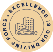 Gold circular badge featuring a car in front of buildings with the text “Excellence is our driving force” around the border.